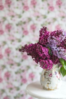 Bouquet of violet lilac in a vintage shabby vase. Still life with blooming branches of lilac in vases. Greeting card mock up.