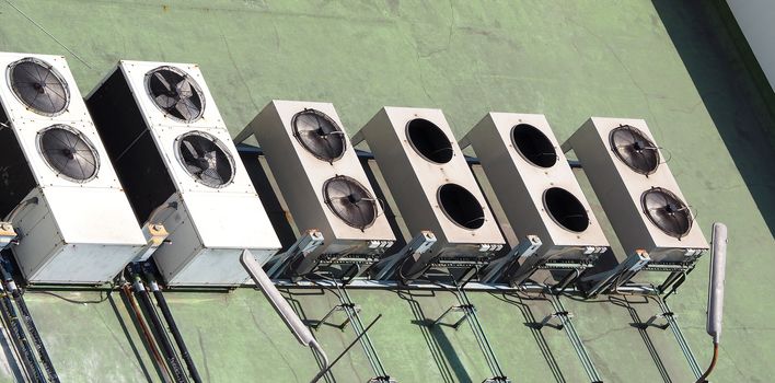 Old air conditioner Compressor on the terrace space and outdoor in summer daytime Bangkok Thailand and top view angle shot.