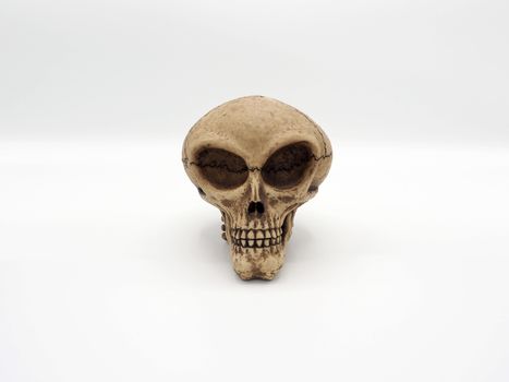 Alien skull toy model which made from plastic racin by hand made and white background studio shot and isolated.