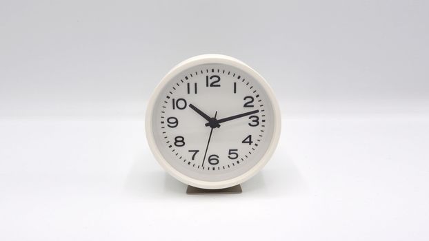 Modern and clean white color clock with minute hand and hour hand on white background and isolated studio shot.