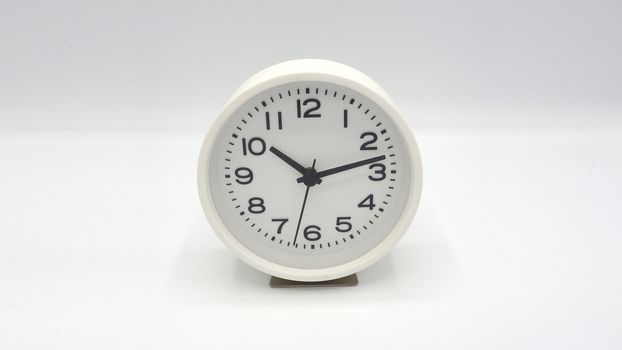 Modern and clean white color clock with minute hand and hour hand on white background and isolated studio shot.