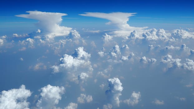 White clouds on the blue sky from airplane view.