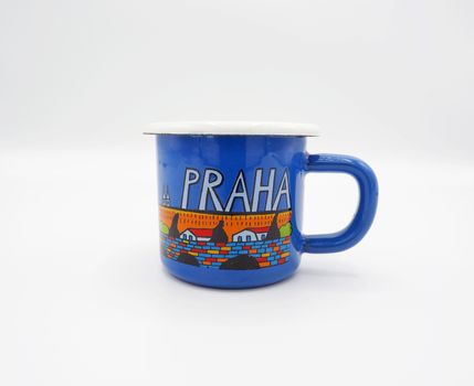 Small tiny and blue colour with hand made art souvenir coffee cup from Praque Czech Replublic and studio shot on white background.