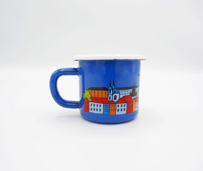 Small tiny and blue colour with hand made art souvenir coffee cup from Praque Czech Replublic and studio shot on white background.