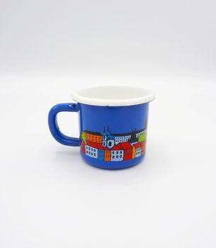 Small tiny and blue colour with hand made art souvenir coffee cup from Praque Czech Replublic and studio shot on white background.