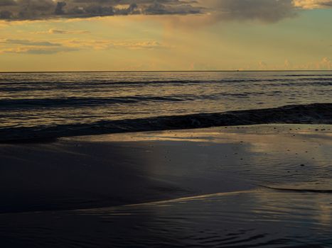 The Baltic Sea at sunset, stormy dramatic clouds. storm Passing over Sea, Sunset and dark clouds after storm. The Vacation, summer concept