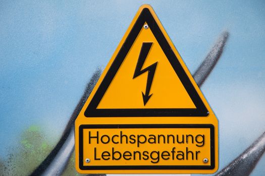 Close-up of a German high voltage caution sign mounted on a wall