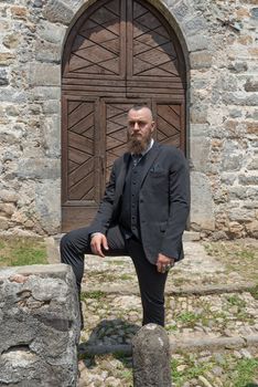 Groom waits for his future wife in front of the church