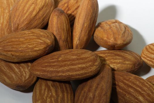 Close-up, almonds, placed together, white background.