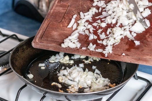 chopped onion put into the pan to fry. Home cooking