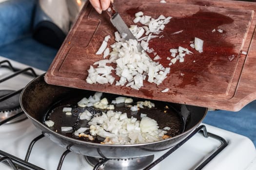 chopped onion put into the pan to fry. Home cooking