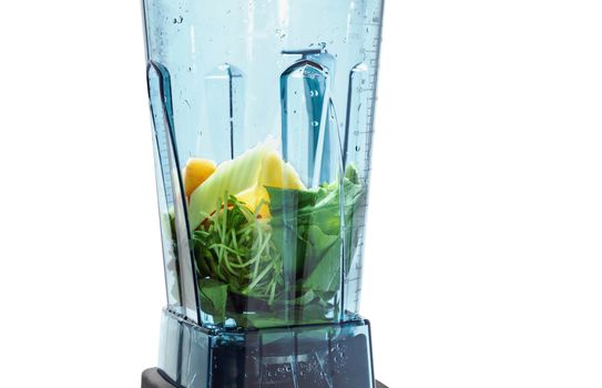 Healthy smoothie for weight loss. Ingredients for healthy smoothie in blender with white background. Ingredients such as: spinach, celery, sprouts, apple.