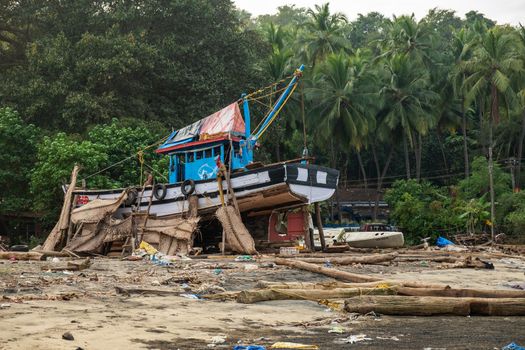 An old wooden fishing boat, now it home to locals, Goa, India