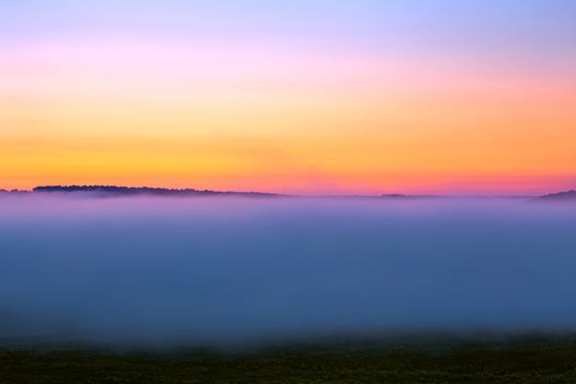 minmalistic foggy sky glow before sunrise without sun.