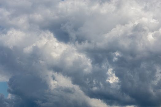 gray incoming storm clouds dark closeup backdrop, captured on telephoto lens