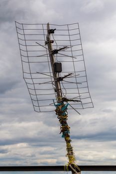 ugly old tv antenna outdoor on overcast sky background with selective focus