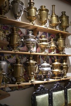 Collection of antique samovars on shelves, Belarus