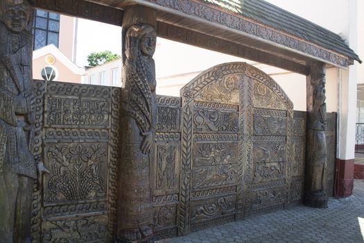 Old wooden gate with a wooden roof, folk ornament, Belarus, Vetka