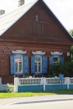 The facade of the old wooden houses in Belarus, with carved architraves