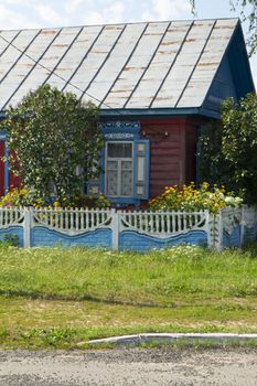 Old typical wooden house in the village in Belarus, vertical image