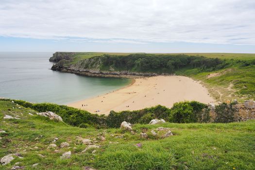 Beautiful sandy beach of Barafundle Bay looking out to the natural sea arches produced by coastal erosion, near Stackpole, Pembrokeshire Coast National Park, Wales, UK