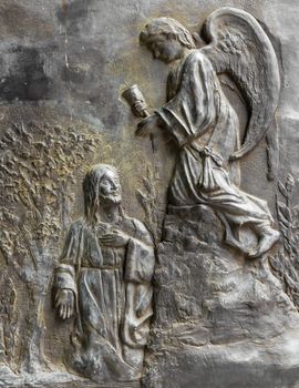 Bas relief depicting Christ kneeling who meets an angel.