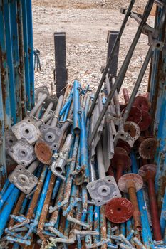 Blue rusty scaffolding, arranged in a row.