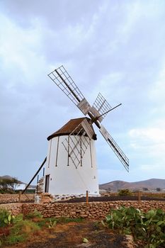 View of traditional windmill against blue sky in Fuerteventura island.