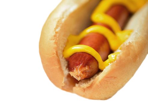 Hot dog with mustard in a plain soft bun isolated over  white background.