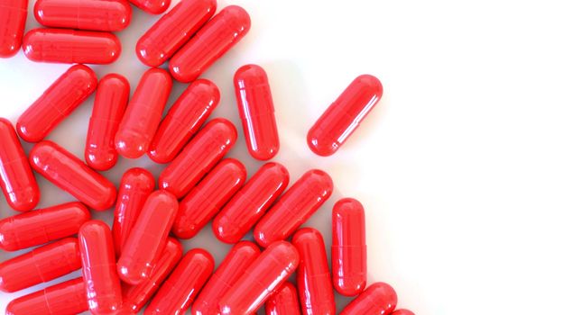 Red capsules on the white background top view.