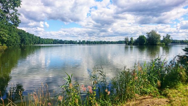 Scenic view of pond against dramatic sky with clouds in South Bohemia, near Trebon city. One of the many ponds near Trebon city in Trebon region.