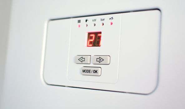 Control panel of the electric boiler with display and control buttons.