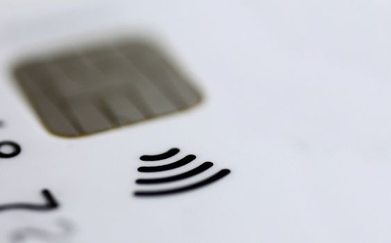 Macro shot of contactless credit card chip with typical sign.