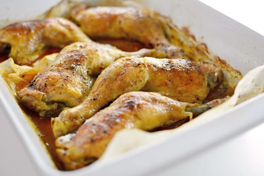 Close Up of a Roasted Chicken Drumsticks in a Roasting Pan.