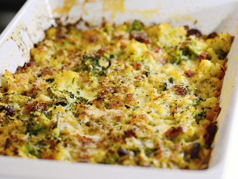 Baked Cauliflower and Broccoli with Grated Parmesan and Pieces of Bacon in the White Porcelain Pan.