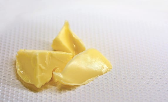 Close-up of a Three Butter Pieces in the Pan.