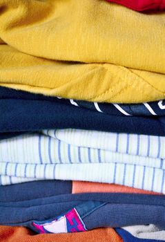 Full frame background of multicolored clothes pile.