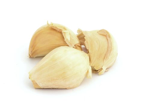 Three cloves of garlic on white background.