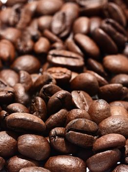 Roasted coffee beans full frame background. Macro shot of coffee beans with visible texture.