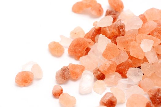 Macro of Pink Himalayan Rock Coarse Salt on White Background.