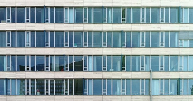 A full frame abstract shot of a modern glass building exterior.