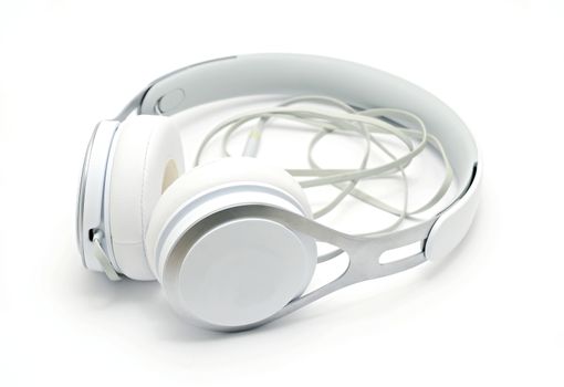 Close up of white headphones on white background.