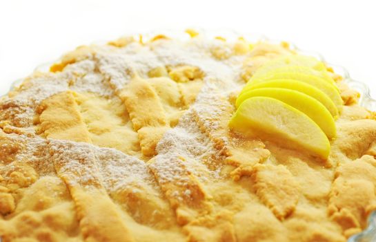 Close up of apple cake with sprinkled sugar heart ornament.