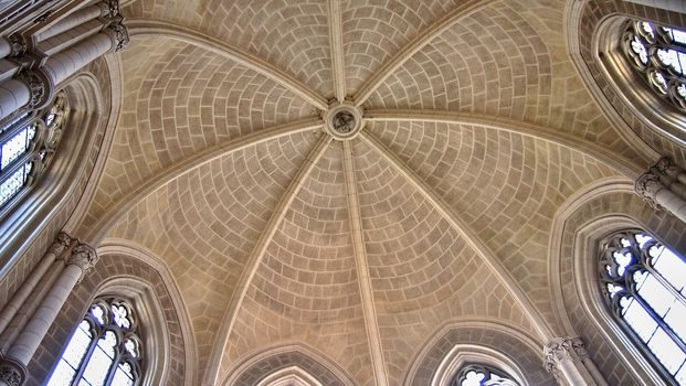Interior look up view of church mosaic tiled dome with windows.