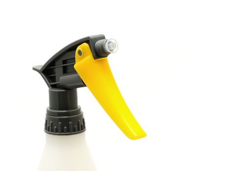 Closeup of plastic yellow grey nozzle head over white background.