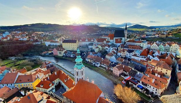 Panoramic aerial view of beautiful town Cesky Krumlov with Vltava river, photo taken against the sun.