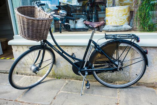 Old bicycle leaning against a shop doorway