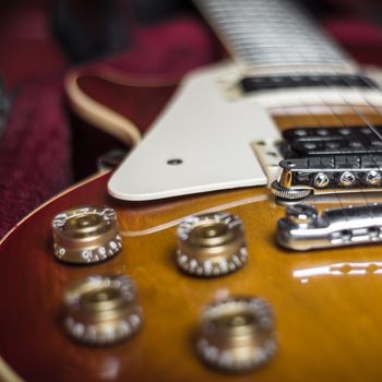 Extreme close-up of an electric guitar in its carry case.