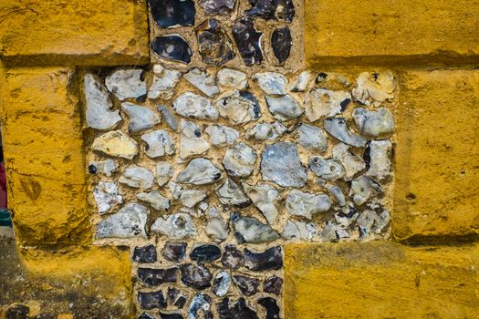 Flint and cotswold stone wall textured background UK