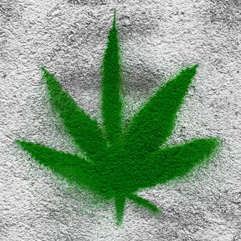 Marijuana leaf drawn on a wall with spray paint.